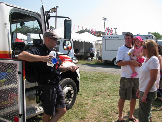 Firefighter King makes sure that he hydrates on a very hot Saturday at the fair.